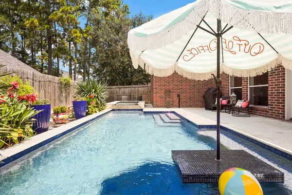 a view of a swimming pool with a patio