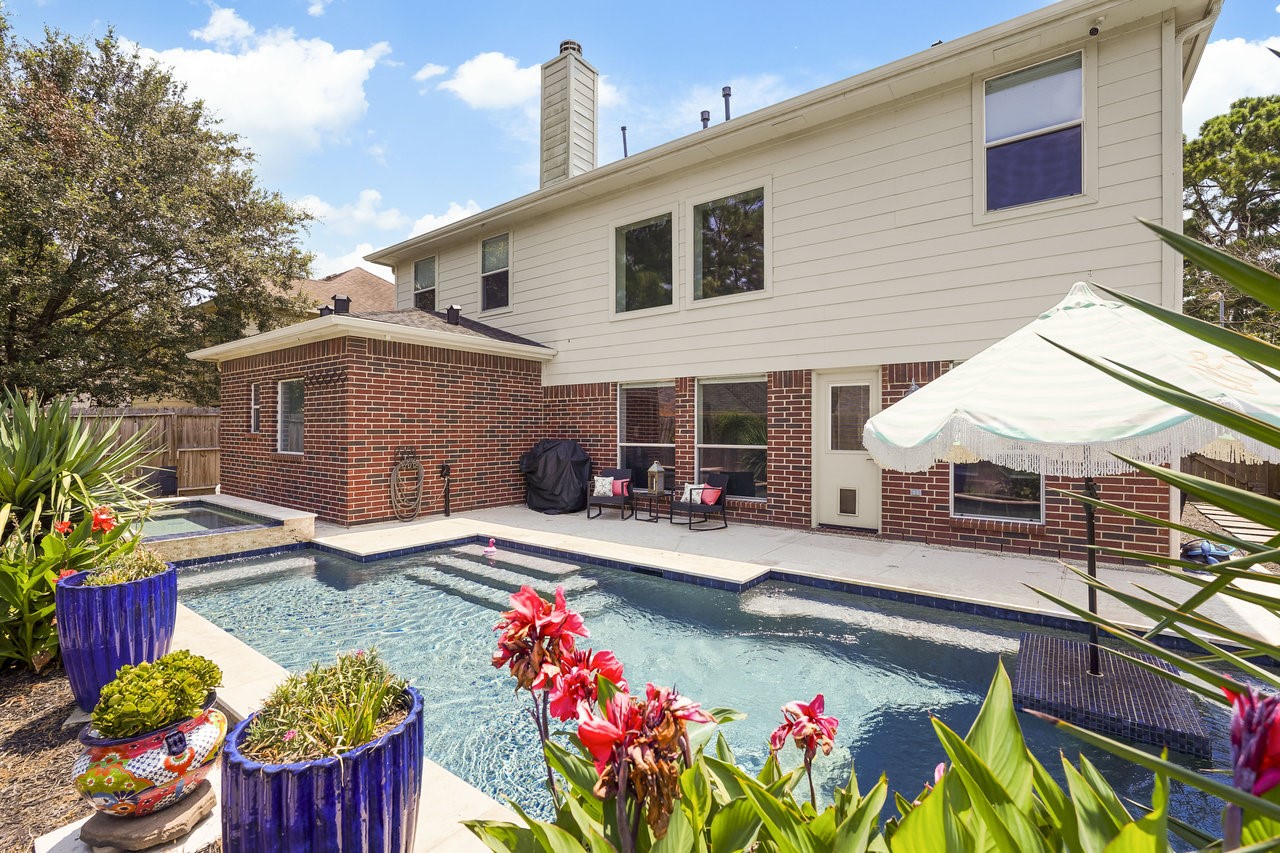 8615 Discus Drive Humble, TX 77346 - Photo 5 of 50 a front view of house with yard outdoor seating and barbeque oven