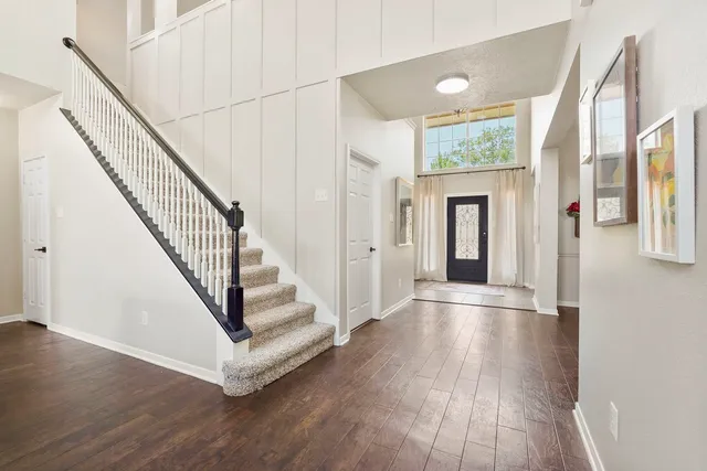 a view of entryway with wooden floor and stairs