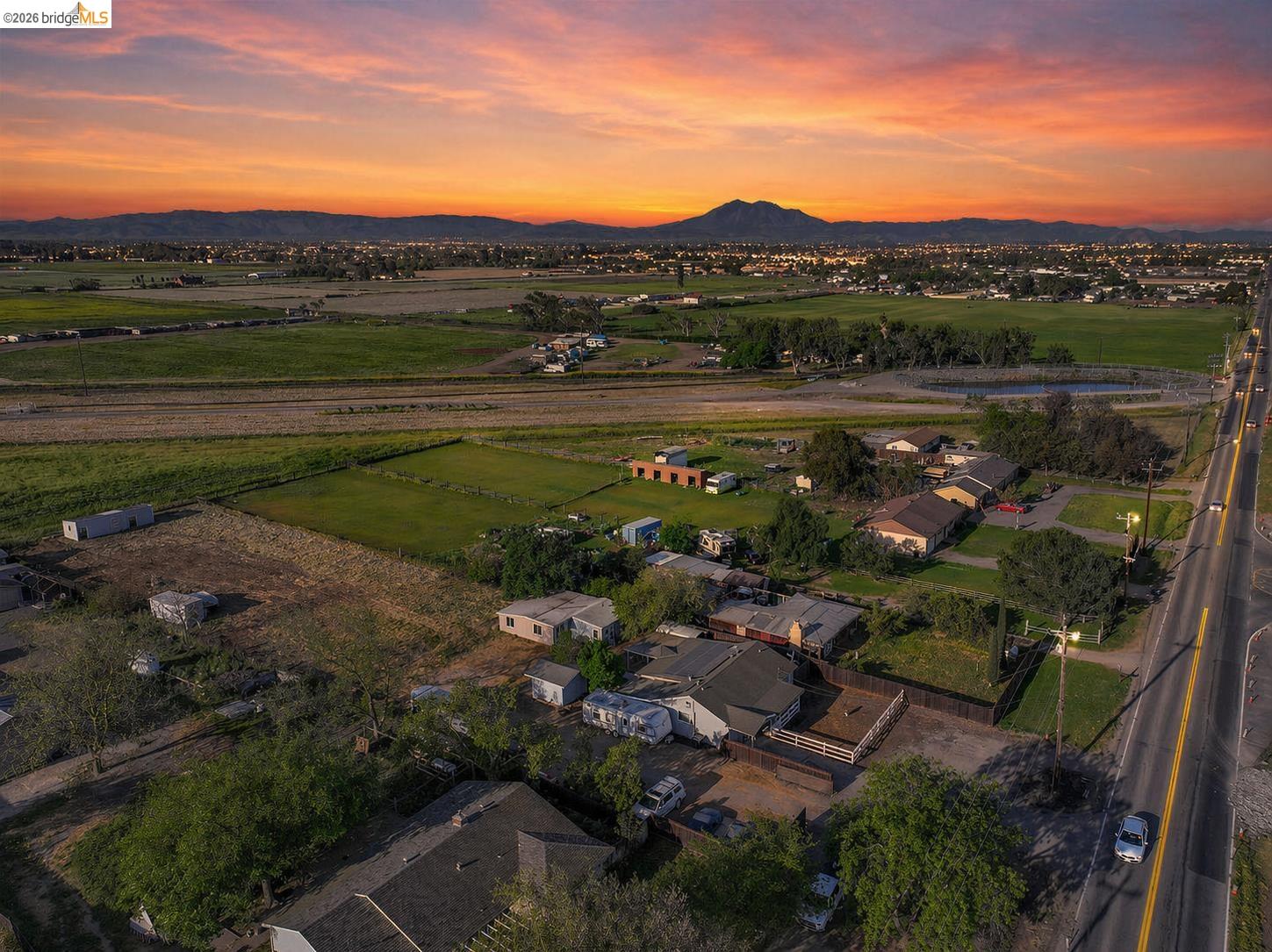 Expansive land parcel featuring open fields and distant mountain ranges