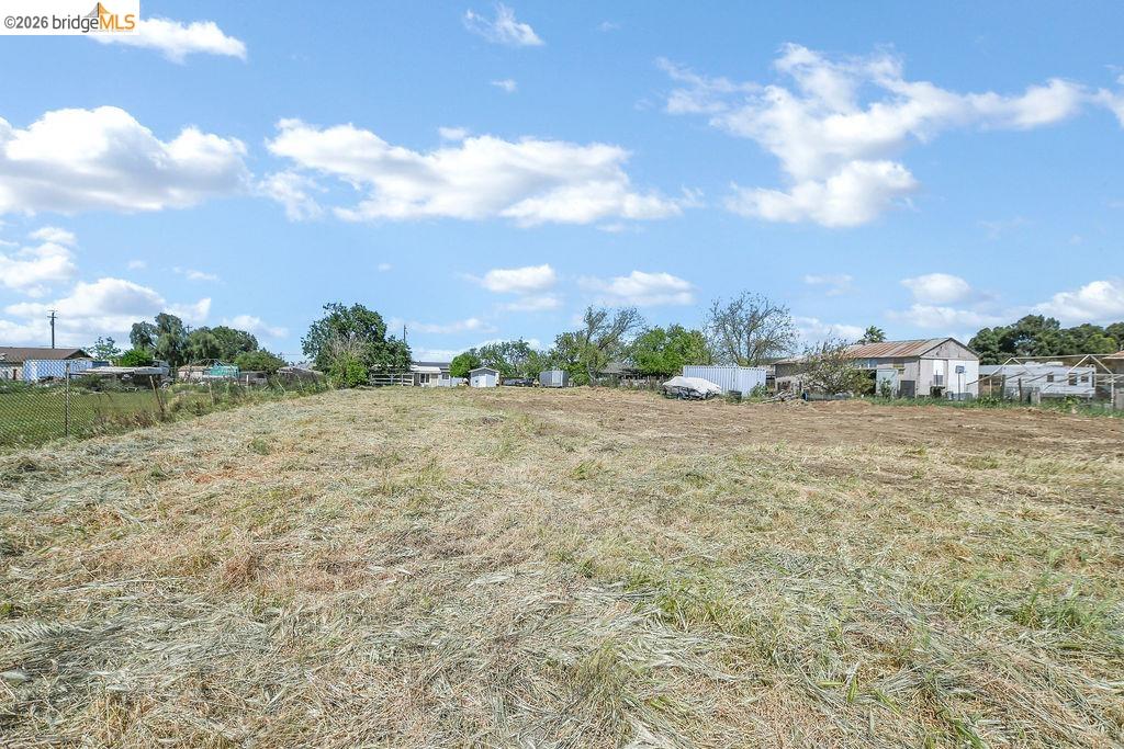 2191 East Cypress Road Oakley, CA 94561 - Photo 37 of 46 a view of a big yard with plants and a brick wall