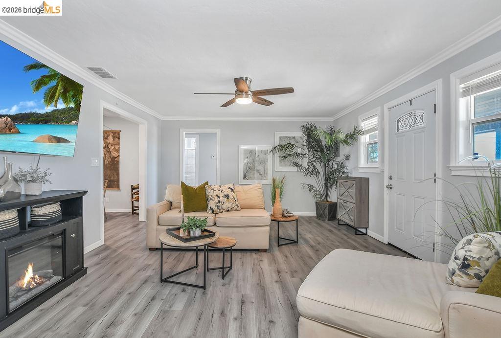 2191 East Cypress Road Oakley, CA 94561 - Photo 5 of 46 a living room with furniture a fireplace and a flat screen tv
