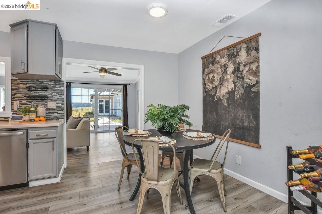2191 East Cypress Road Oakley, CA 94561 - Photo 6 of 46 a dining room with furniture and wooden floor