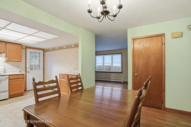 a view of a room with furniture and wooden floor