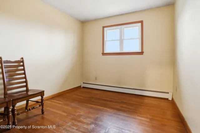 a bedroom with a bed and painting on the wall