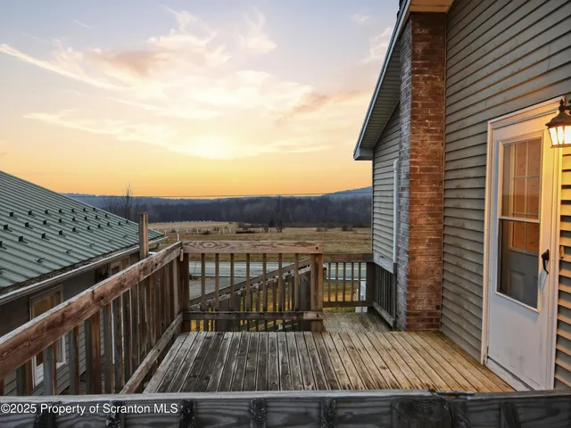 a view of balcony with wooden floor and city view