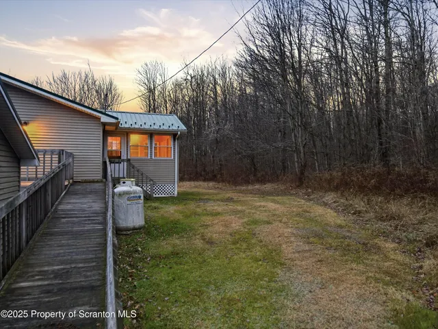 a view of deck with wooden floor and floor to ceiling window and wooden fence