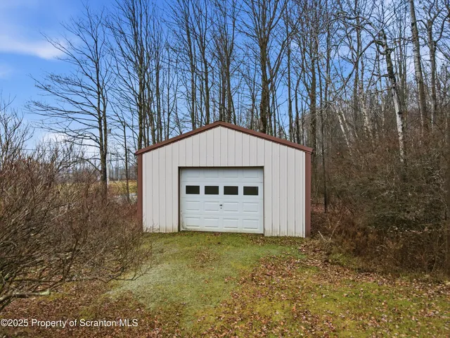 a view of a house with a yard and garage