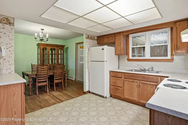a kitchen with refrigerator cabinets dining table and chairs