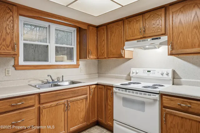 a kitchen with stainless steel appliances granite countertop a sink stove and cabinets
