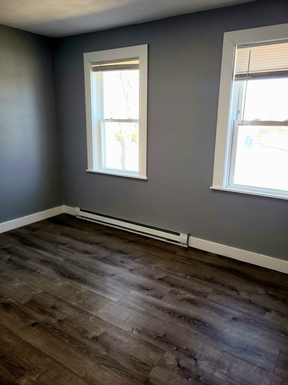136 Commonwealth Road Wayland, MA 01778 - Photo 20 of 27 an empty room with wooden floor and windows