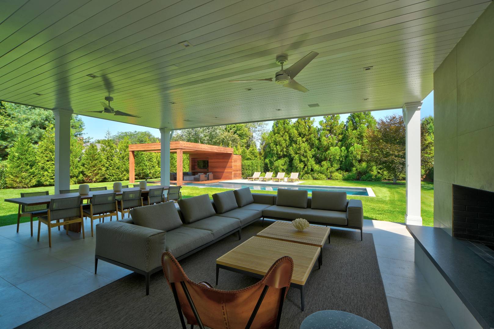 132 Long Lane East Hampton, NY 11937 - Photo 16 of 24 a living room with patio furniture and a fireplace