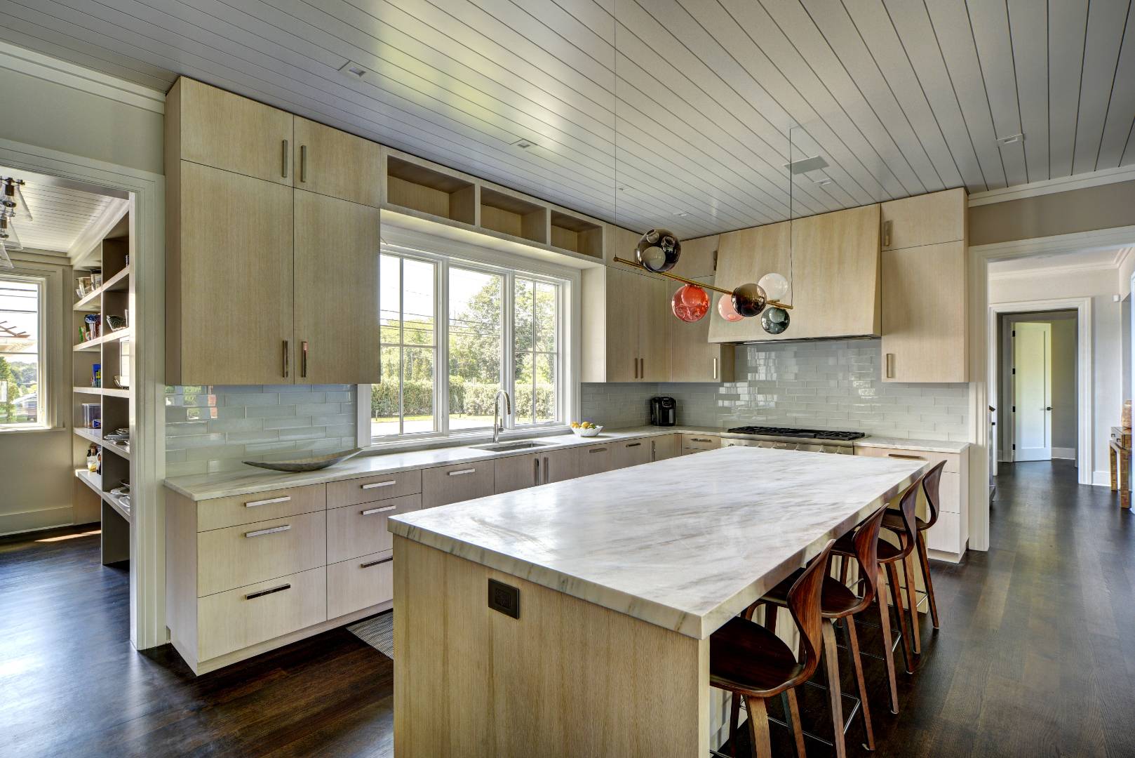 132 Long Lane East Hampton, NY 11937 - Photo 4 of 24 a kitchen with granite countertop a table chairs sink and cabinets
