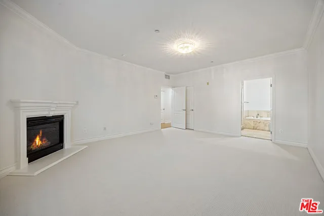 a view of an empty room with fire place and a fireplace