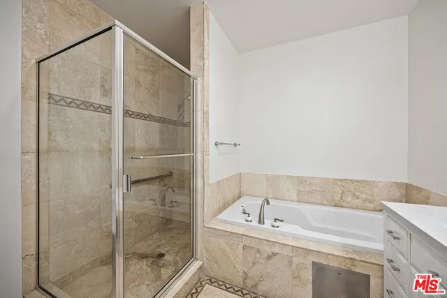 a bathroom with a bathtub and shower