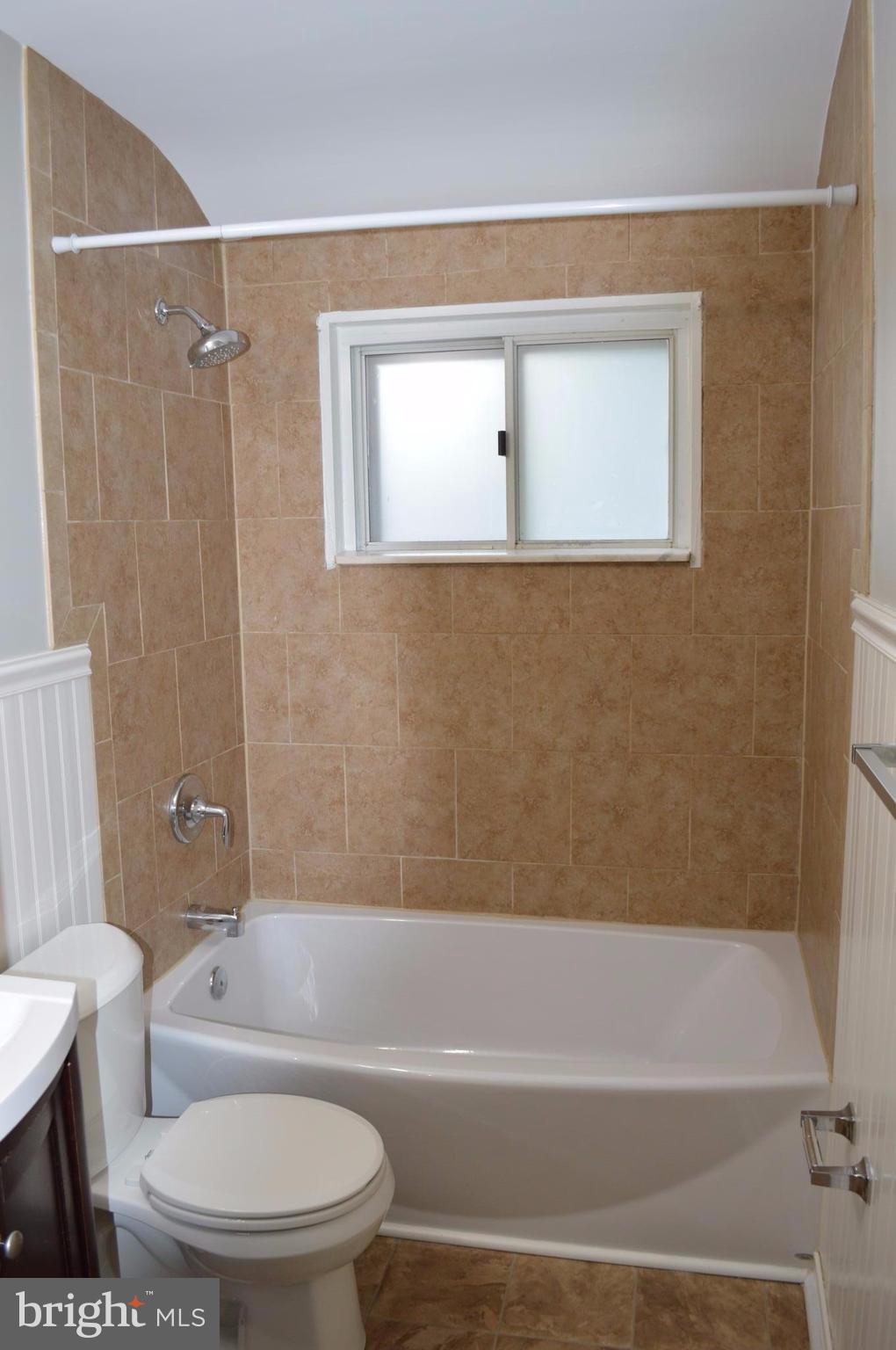 8223 Kavanagh Road Baltimore, MD 21222 - Photo 12 of 17 a bathroom with a toilet and a bathtub