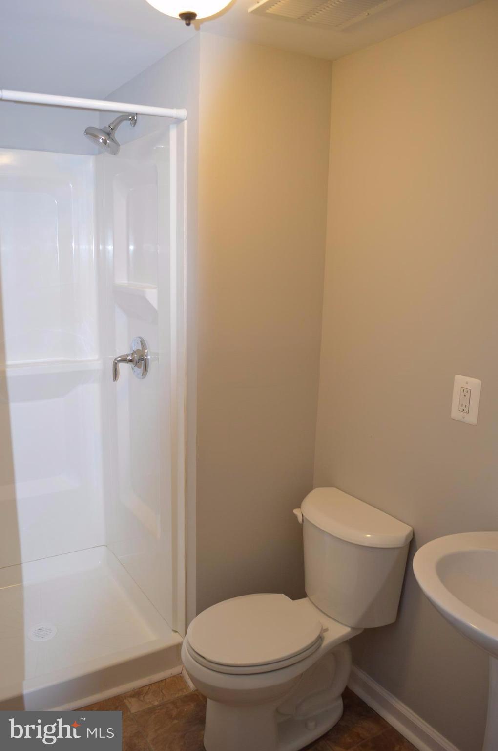 8223 Kavanagh Road Baltimore, MD 21222 - Photo 15 of 17 a white toilet sitting next to a shower
