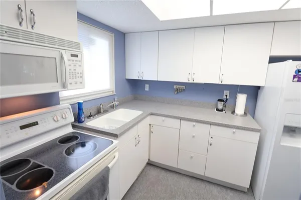 a kitchen with a sink stove and cabinets