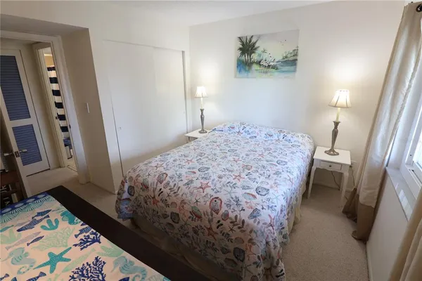 a bedroom with a bed and a dresser in it