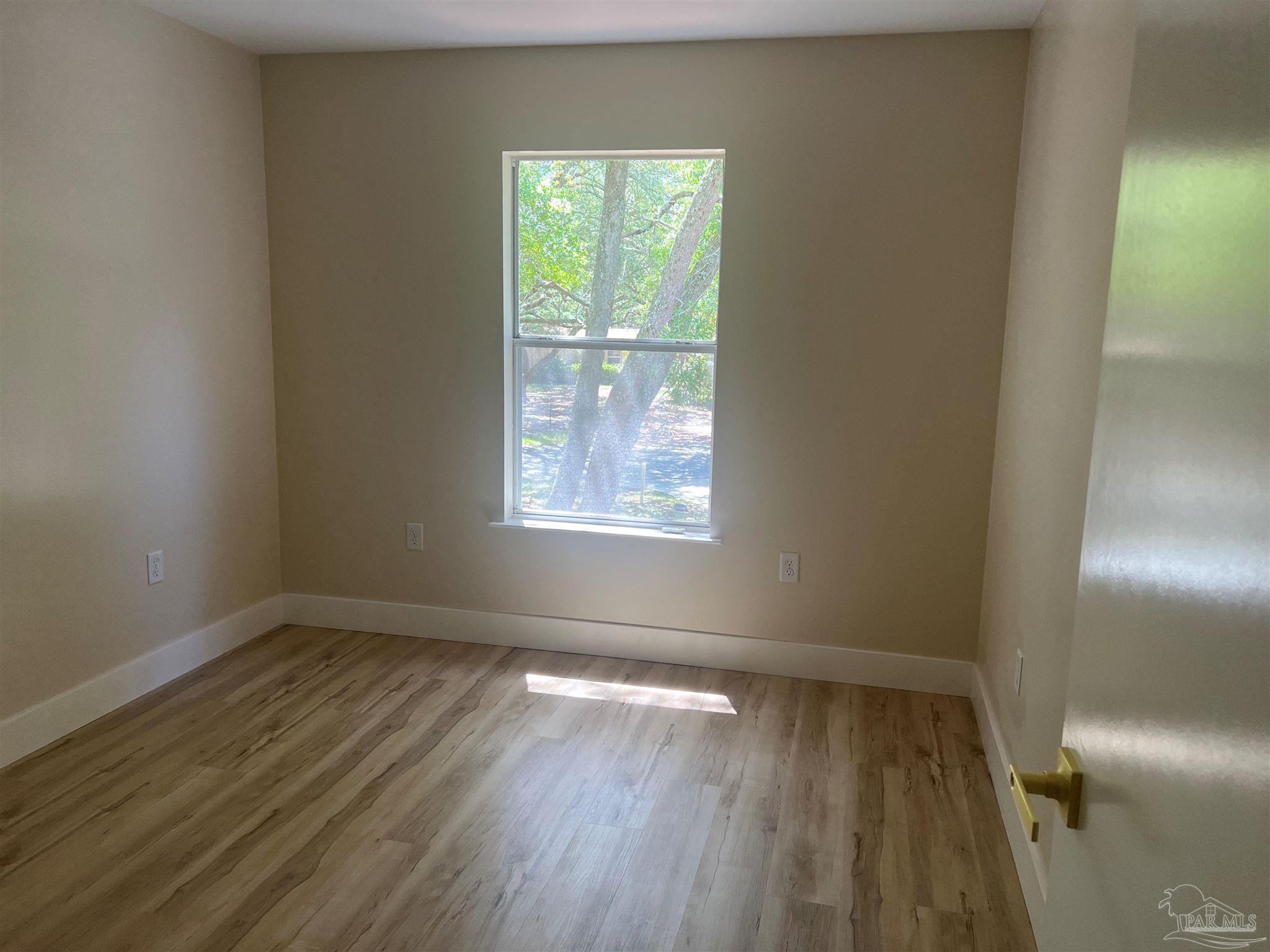 3111 Holley Point Road Navarre, FL 32566 - Photo 10 of 23 a view of empty room with wooden floor