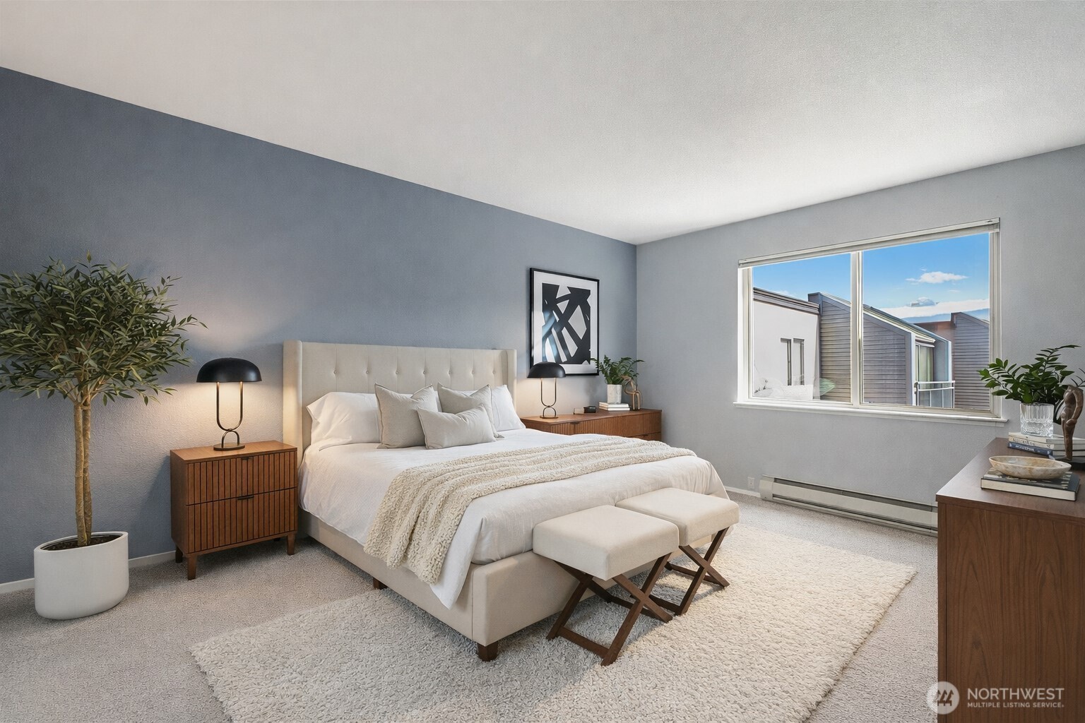 275 West Roy Street, Unit 412 Seattle, WA 98119 - Photo 11 of 34 a bedroom with a bed and a potted plant on table