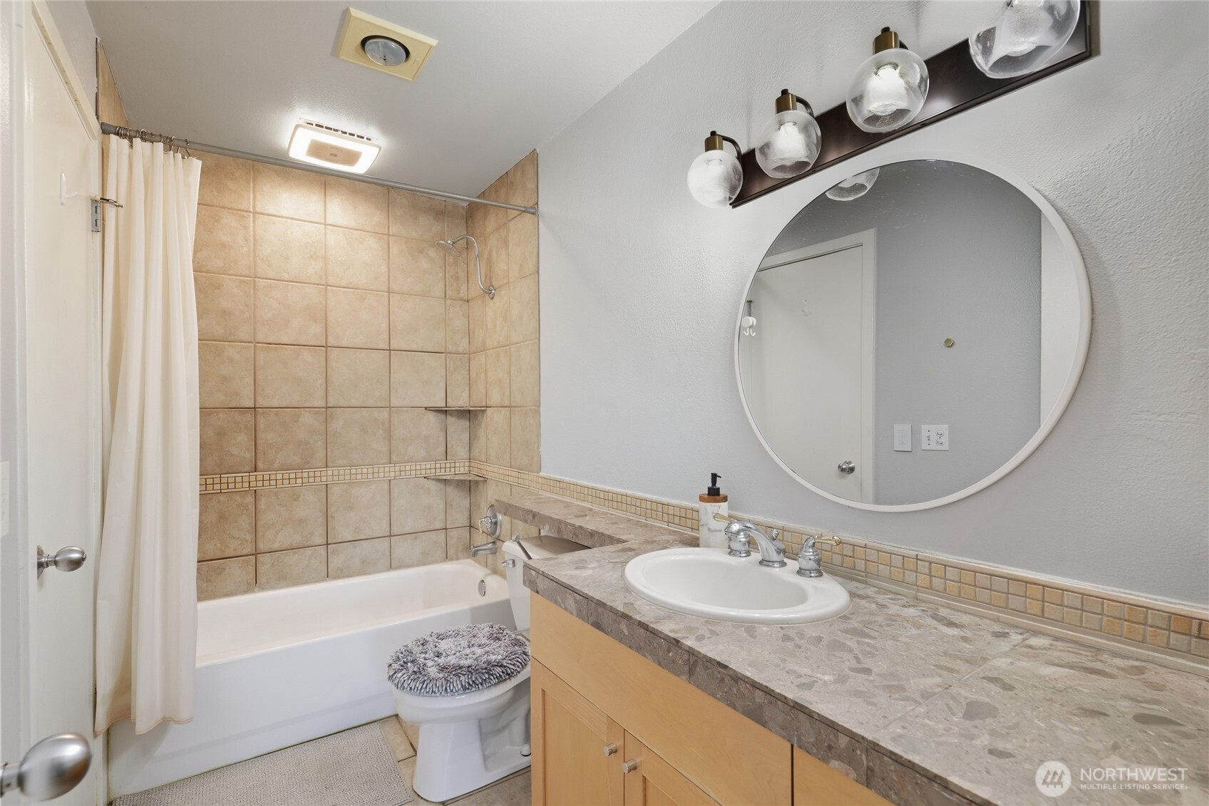 275 West Roy Street, Unit 412 Seattle, WA 98119 - Photo 12 of 34 a bathroom with a sink a toilet and shower