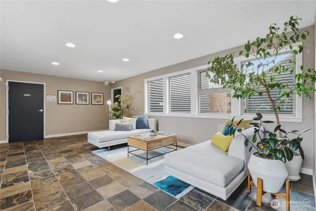 a living room with furniture and a potted plant
