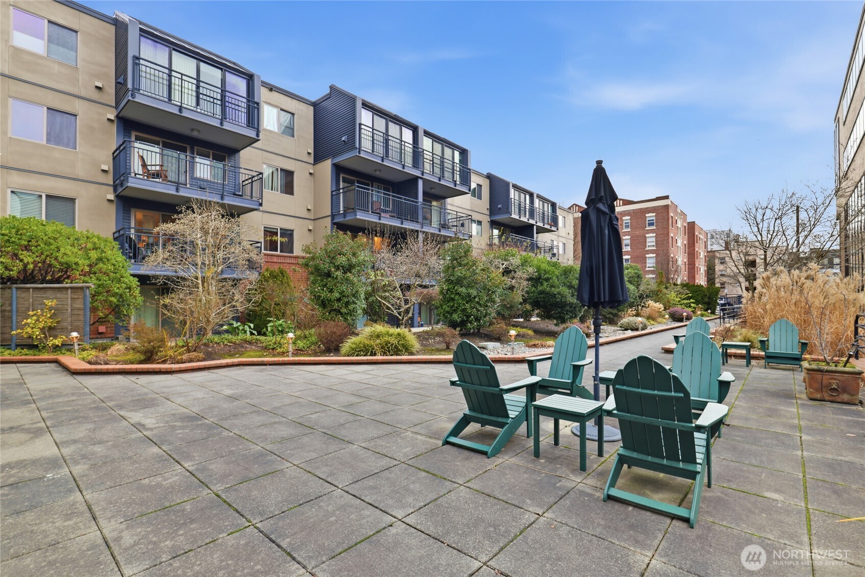 275 West Roy Street, Unit 412 Seattle, WA 98119 - Photo 17 of 34 a view of a patio with a table and chairs and potted plants