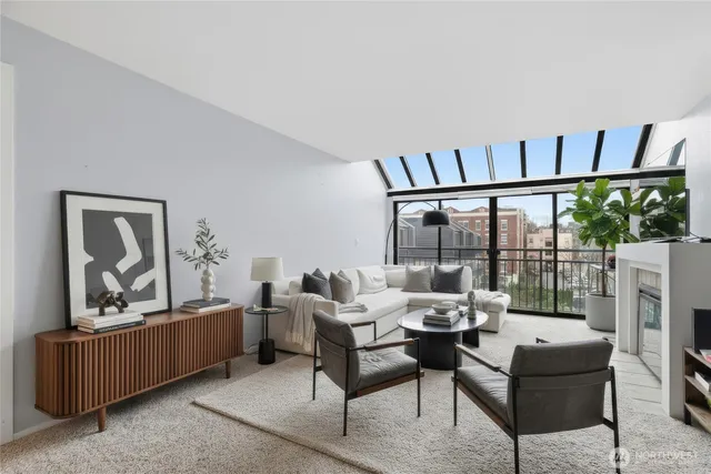 a living room with furniture and a floor to ceiling window