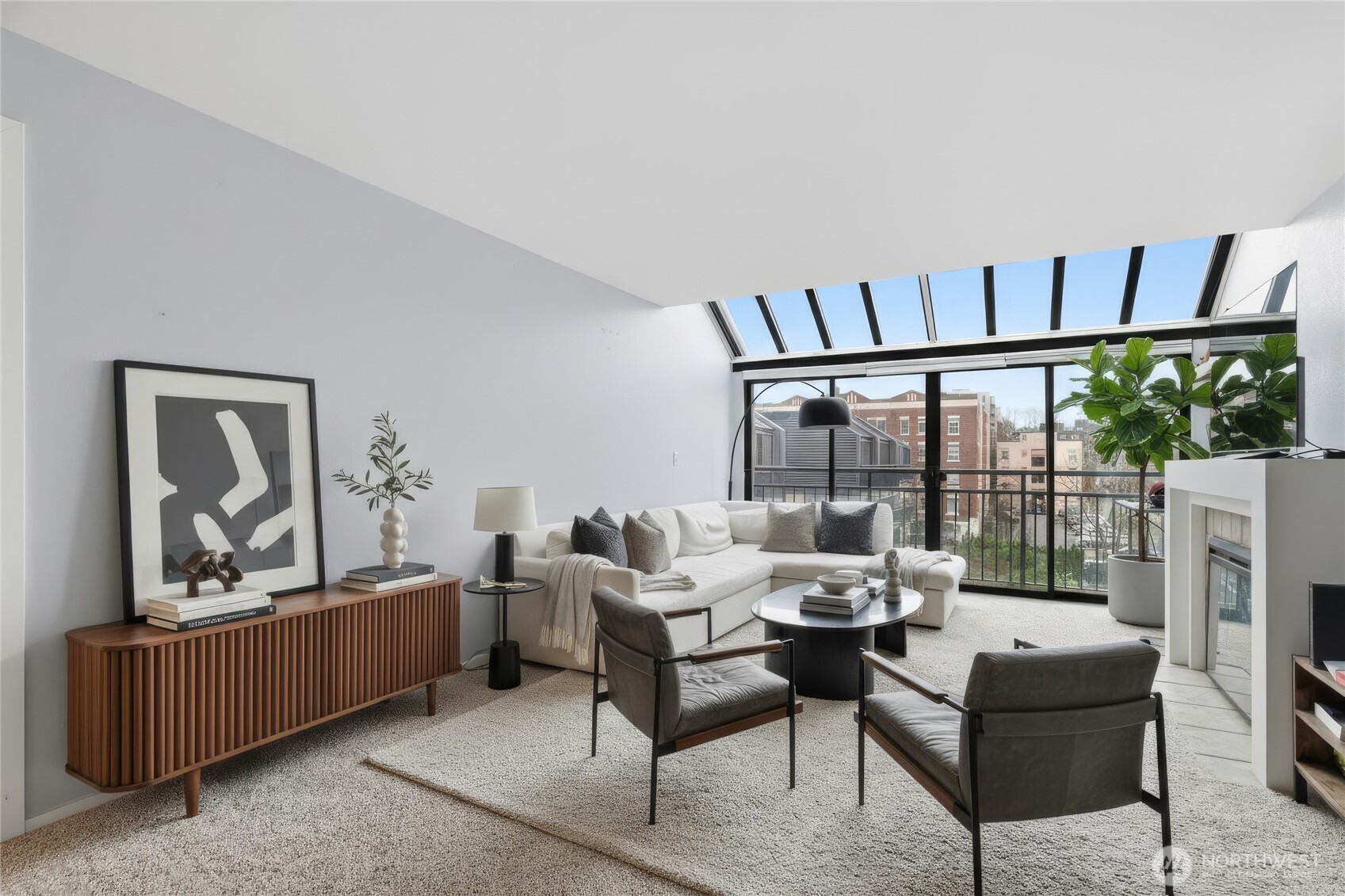 275 West Roy Street, Unit 412 Seattle, WA 98119 - Photo 3 of 34 a living room with furniture and a floor to ceiling window