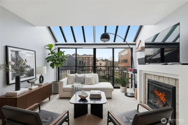 a living room with furniture fireplace and flat screen tv