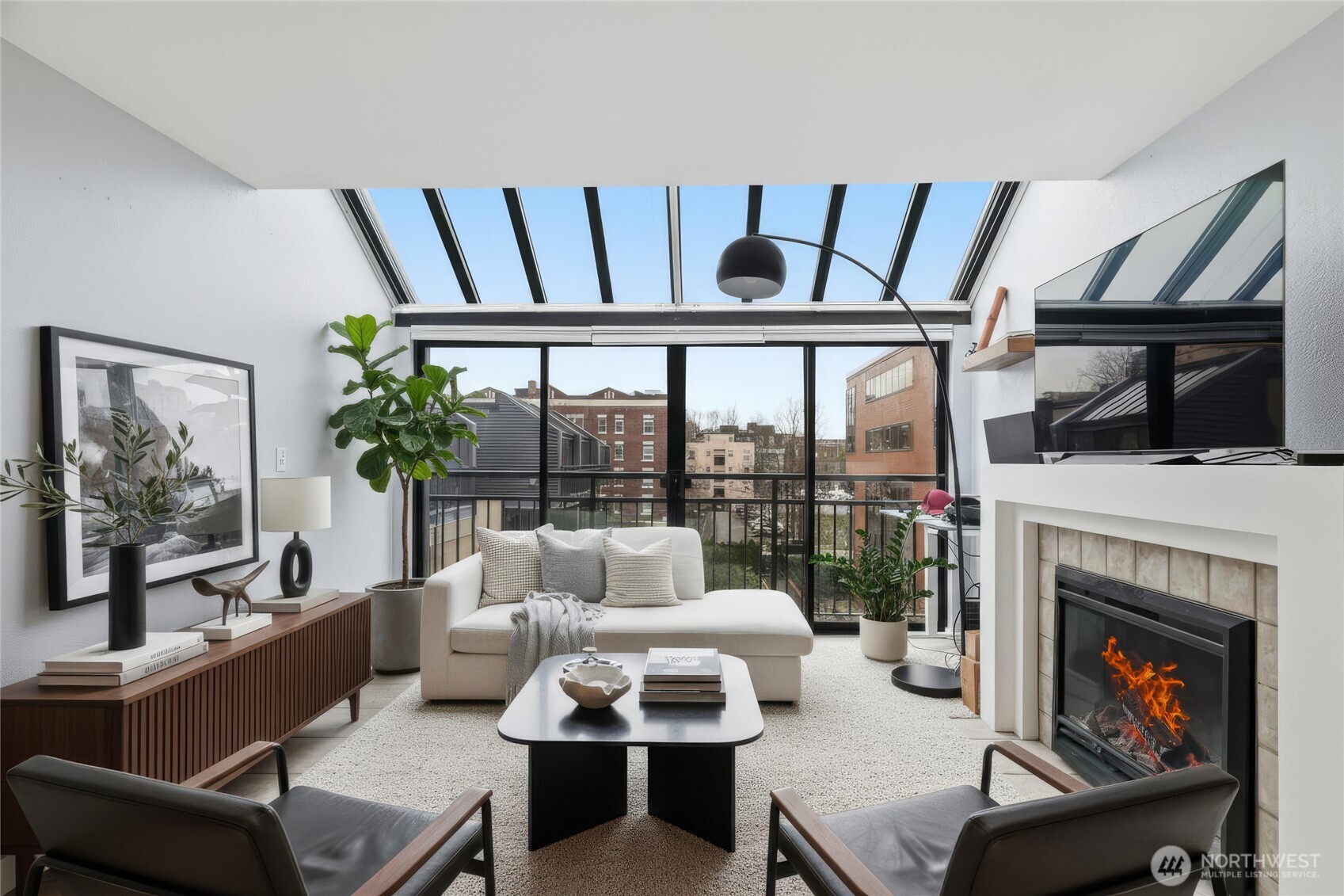 275 West Roy Street, Unit 412 Seattle, WA 98119 - Photo 4 of 34 a living room with furniture fireplace and flat screen tv