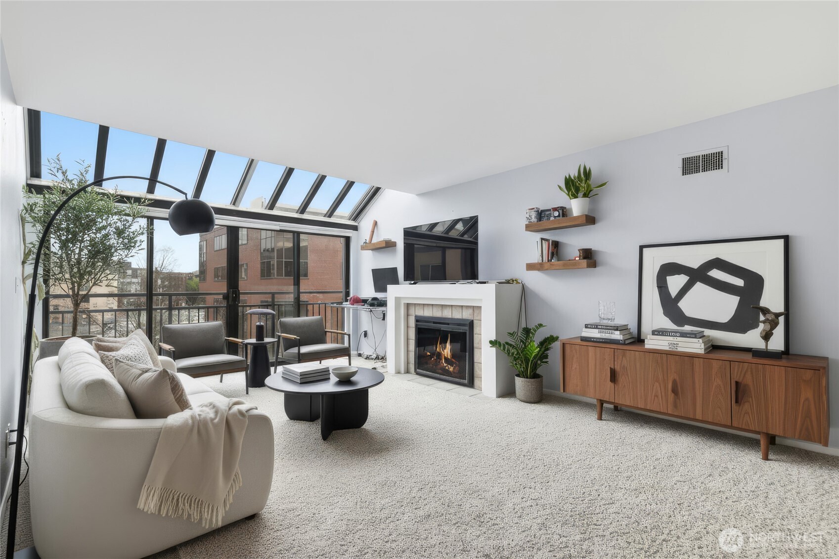275 West Roy Street, Unit 412 Seattle, WA 98119 - Photo 5 of 34 a living room with furniture a fireplace and a flat screen tv