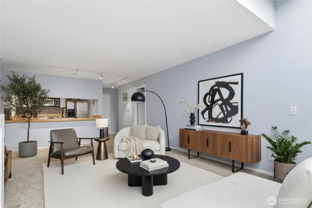 a living room with furniture and a potted plant