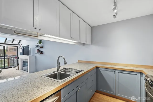 a kitchen with granite countertop a sink and cabinets