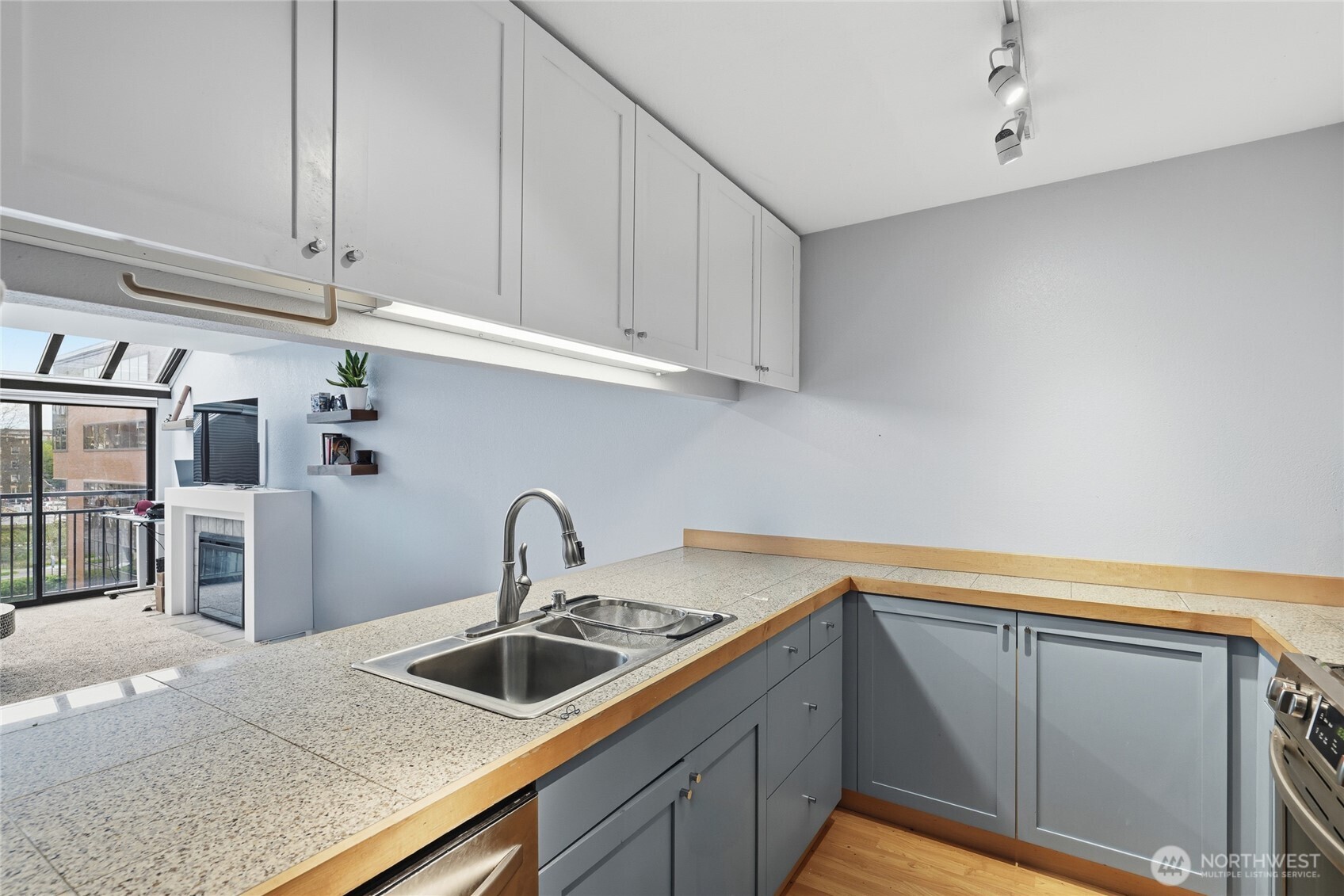 275 West Roy Street, Unit 412 Seattle, WA 98119 - Photo 8 of 34 a kitchen with granite countertop a sink and cabinets