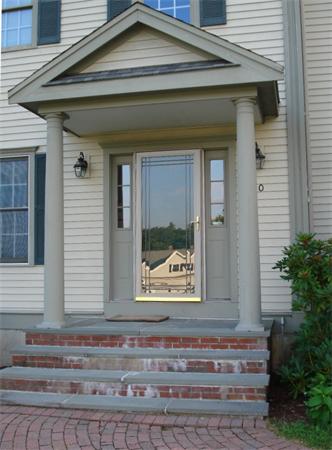 50 Deerpath Road Dedham, MA 02026 - Photo 2 of 13 a front view of a house with a window and potted plants