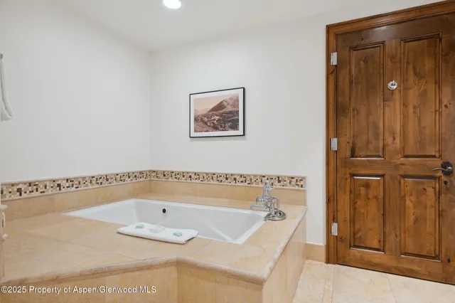 a bathroom with a tub and shower