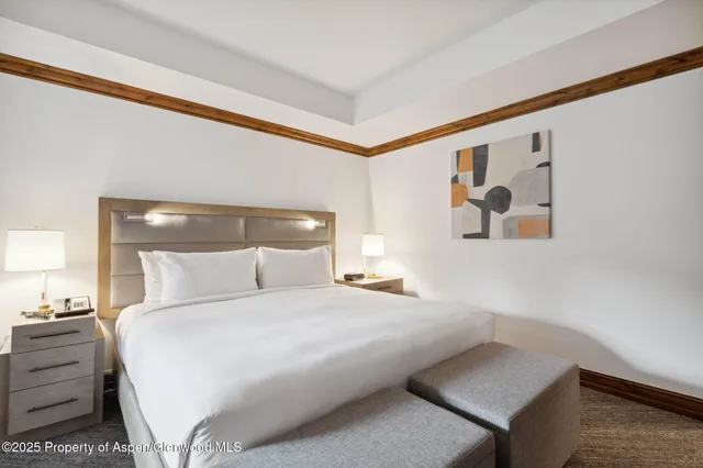 a bedroom with a bed and a night stand