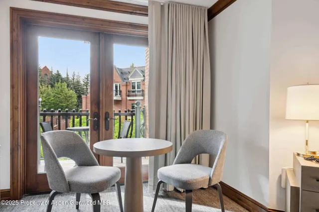 a view of a dining room with furniture and a potted plant