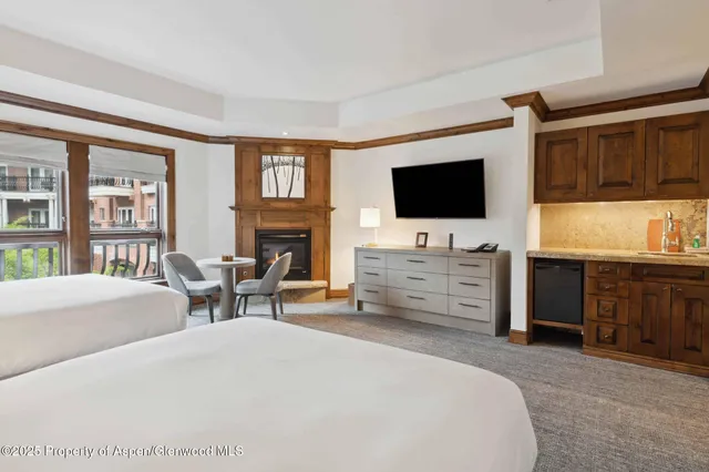 a bed room with furniture and a flat screen tv