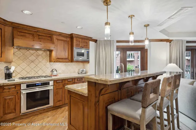 a kitchen with a sink stove and wooden floor