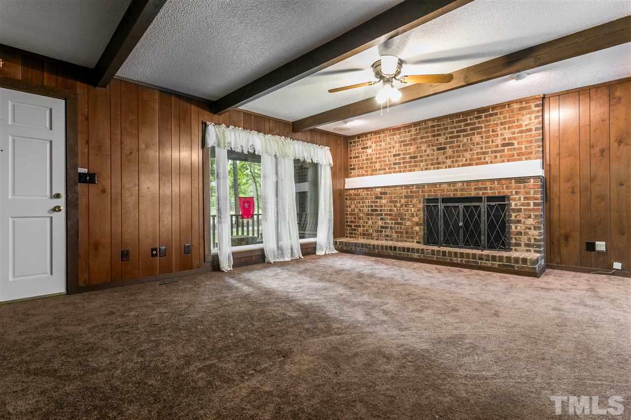 4609 Forestville Road Raleigh, NC 27616 - Photo 2 of 4 a view of empty room with floor to ceiling window and fireplace