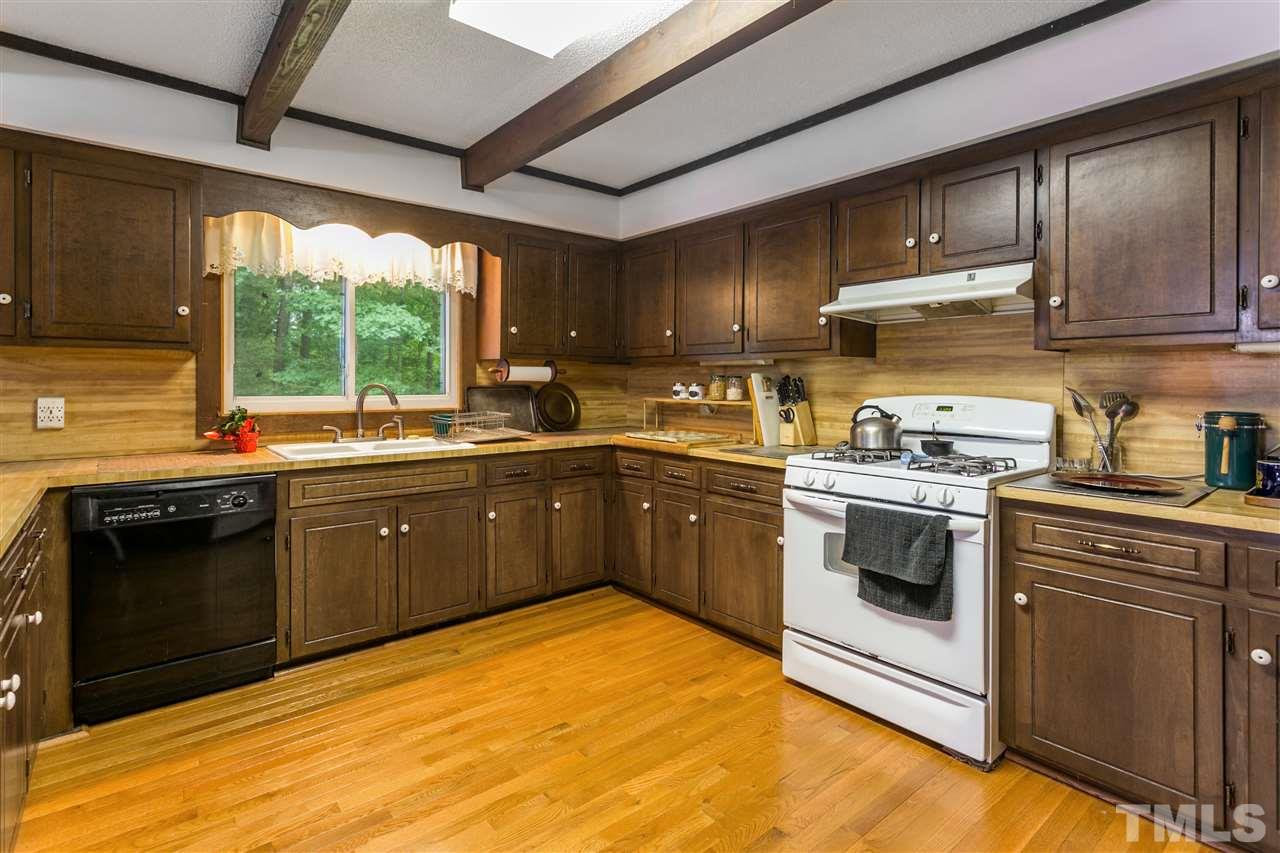 4609 Forestville Road Raleigh, NC 27616 - Photo 3 of 4 a kitchen with a sink a stove and cabinets
