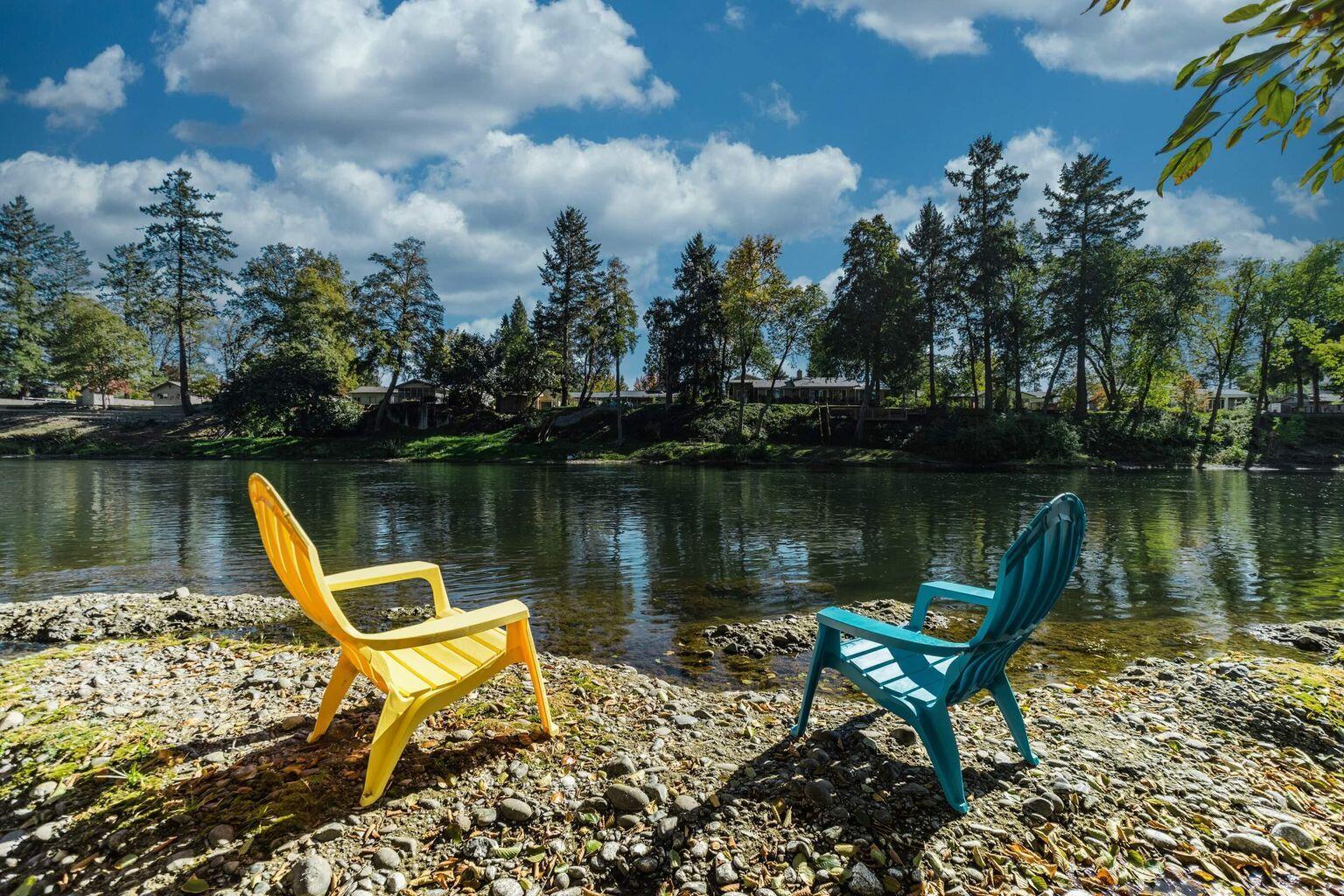 a view of a lake with a table and chairs