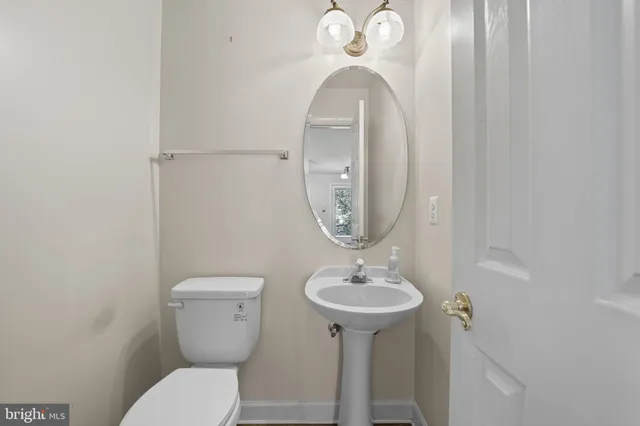 a large kitchen with stainless steel appliances a stove a sink dishwasher and white cabinets with wooden floor