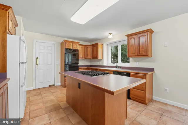 a kitchen with stainless steel appliances a sink stove and cabinets