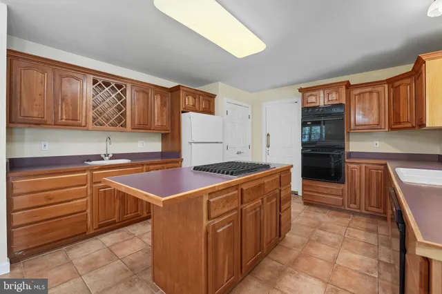 a kitchen with granite countertop a sink and a stove