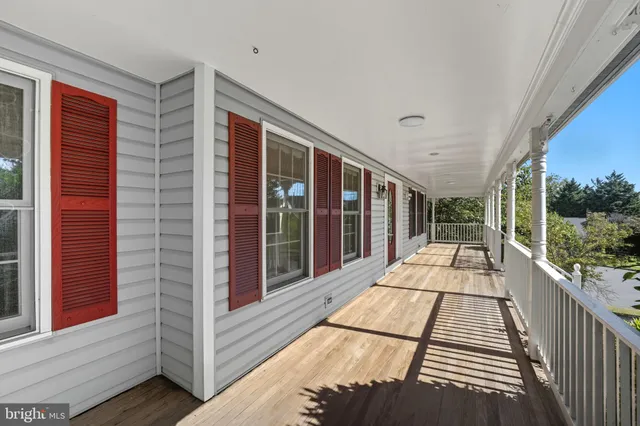 a view of balcony with a large window and wooden floor