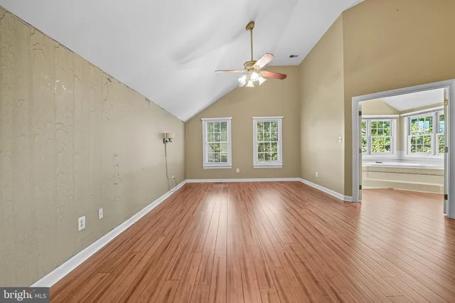 a view of a room with wooden floor